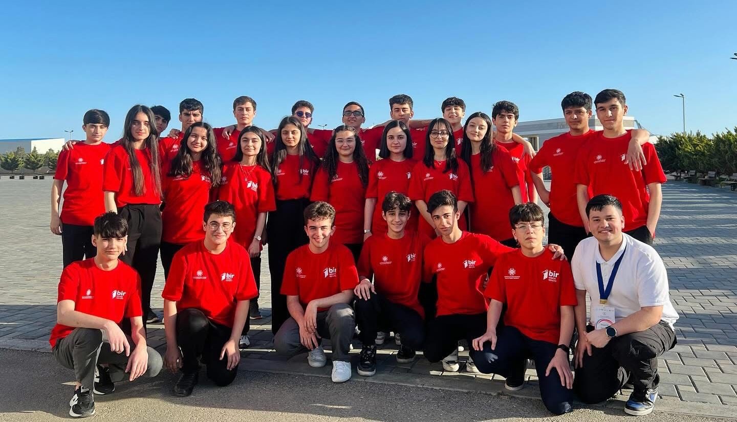 Young volunteers in red VolunTrack shirts