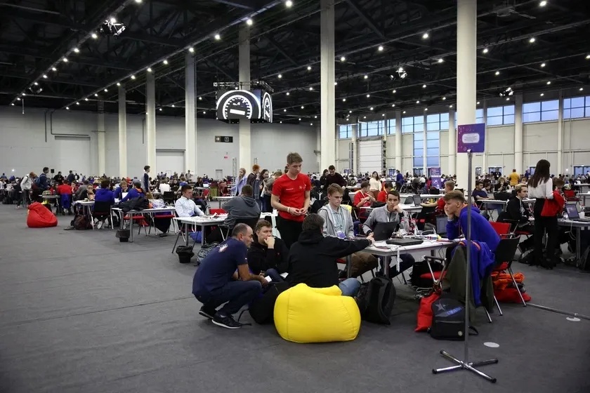 Volunteers at a hackathon in a large hall